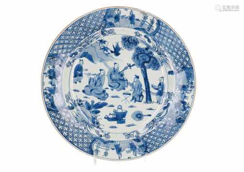 A blue and white porcelain charger, decorated with musicians in a landscape. Unmarked. China,