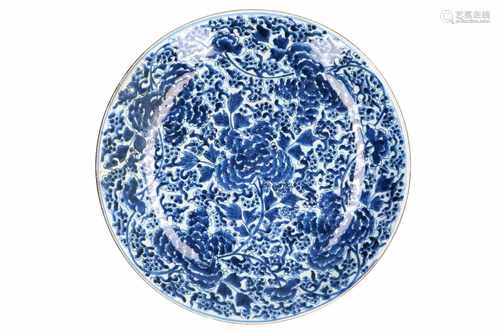 A blue and white porcelain charger, decorated with peonies. Marked with sacred fungus Kangxi. China,