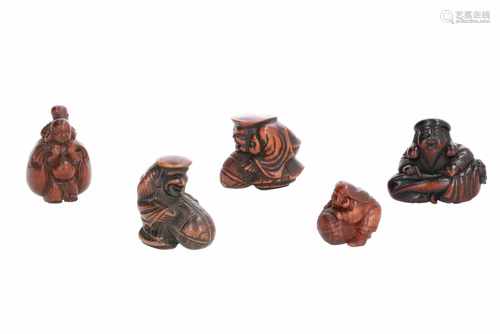 Lot of five netsuke, 1) Wooden sitting Daikoku with two-forked radish. Signed Hozan. H. 4 cm. 2)