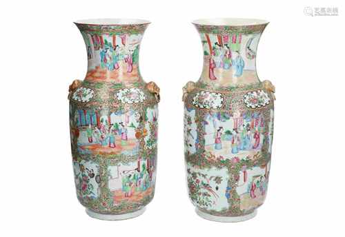 A pair of polychrome porcelain vases, decorated with birds, flowers and several scenes with figures.