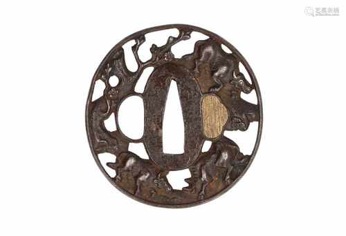 Iron tsuba with relief decor of oxes and flowers. Japan, late Edo period. Diam. 6,5 cm.