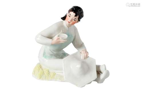 A polychrome porcelain sculpture of a lady with rice bowl and hat. Unmarked. China, 20th century. H.