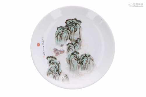 A polychrome porcelain dish, decorated with a mountainous landscape. Dated 1990. Signed Wang Qiu Xia