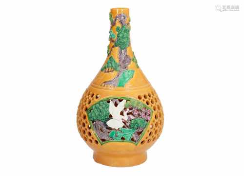 A polychrome open work porcelain vase, decorated with birds, flowers and trees. Marked with seal