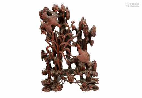 A carved wooden sculpture depicting two birds in a tree. China, ca. 1900. H. 32 cm.