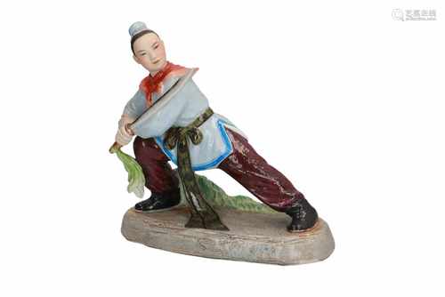 A polychrome porcelain sculpture of a female warrior. Marked. China, 20th century. H. 20 cm.