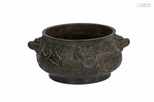 A bronze censer with relief decor of dragons and clouds. The grips in the shape of animal heads. The