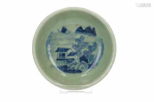 A celadon bowl, decorated with a boat and house in a river landscape. Marked with 4-character