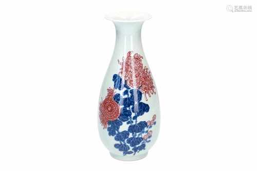 A blue and white with underglaze red porcelain vase, decorated with flowers. Marked with 6-character