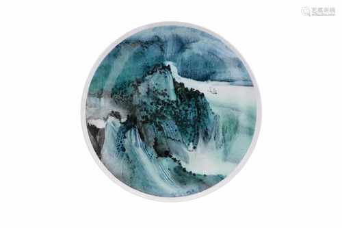 A polychrome porcelain dish, decorated with a mountainous river landscape. Signed Li Linhong (1942),