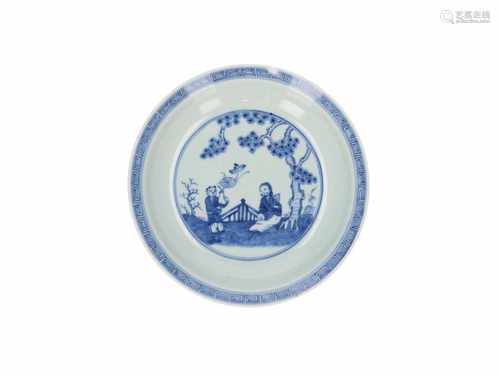 A blue and white porcelain deep dish decorated with two figures under a tree. Marked with seal