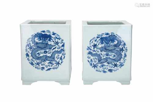 A pair of blue and white porcelain square cashepots, decorated with cartouches with phoenix and