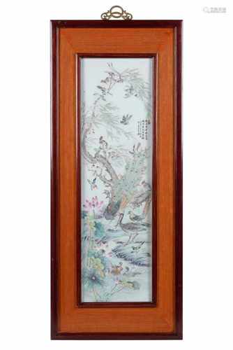 A polychrome porcelain rectangular plaque in wooden frame, depicting birds and peacock. Dated