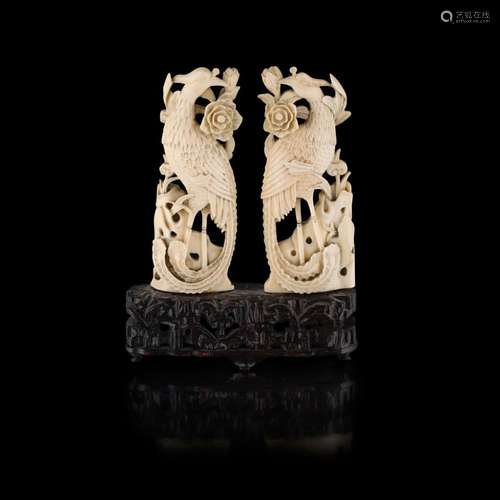 Y PAIR OF CARVED IVORY PHOENIX QING DYNASTY, 19TH CENTURY 12.5cm high (excluding stand)