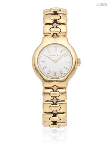 Ref: L0133, Circa 2000  Tiffany & Co. A lady's 18K gold quartz bracelet watch