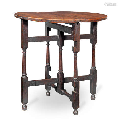 An early 18th century joined elm and oak folding or coaching table, English, circa 1710-30