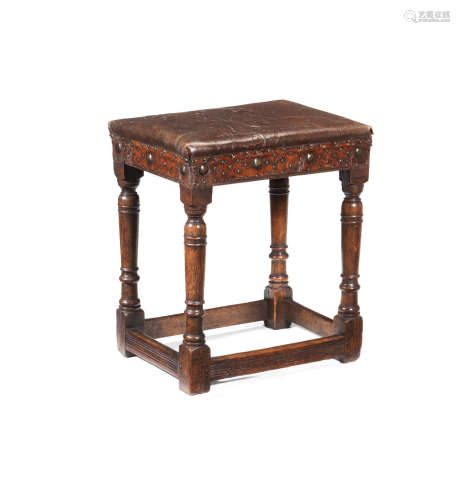 A James I joined oak and leather upholstered stool, circa 1620