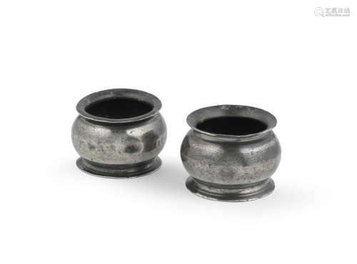 A pair of George III pewter bulbous salts,