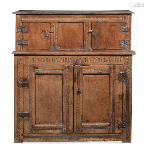 With historic scumbled finish An unusual and small Charles I joined and boarded livery cupboard, West Country, circa 1630