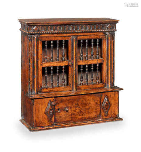 A mid-17th century fruitwood joined and boarded mural livery cupboard, circa 1650-1700 and later