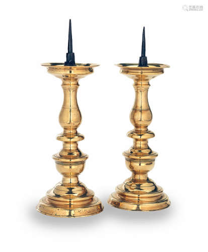 A pair of late 16th/early 17th century brass and iron pricket candlesticks, Flemish, circa 1600