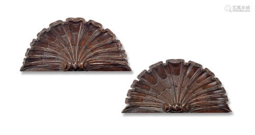 A pair of 18th century carved walnut architectural scallop shell crests
