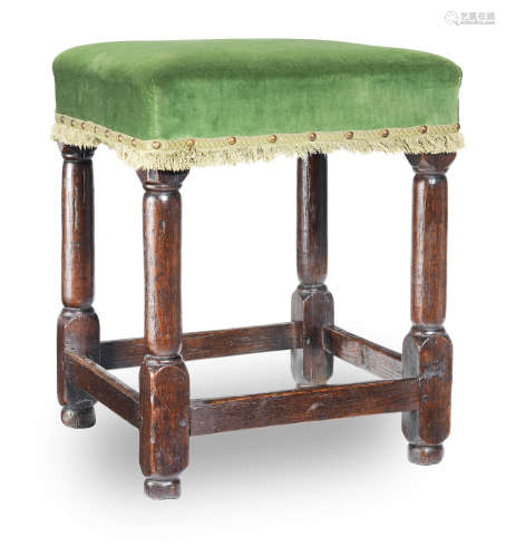 A mid-17th century joined oak upholstered stool, English, circa 1650
