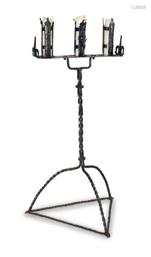A wrought iron standing candleholder, in Medieval style