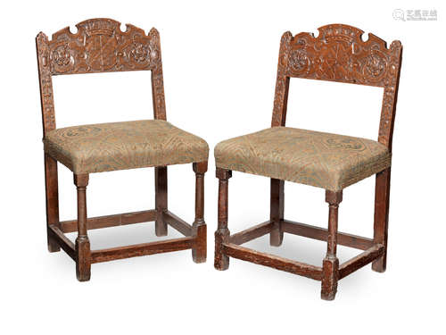 Carved with the arms of Sir Henry D'Anvers, Earl of Danby, (1573 - 1643) A pair of early 17th century joined walnut open-back chairs, Anglo-French, possibly Guernsey, circa 1630