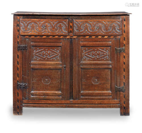 A Charles I joined oak and inlaid cupboard with drawers, North Country, circa 1640