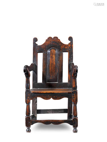 An early 18th century oak and elm panel-back open armchair, English or Welsh, circa 1700-30