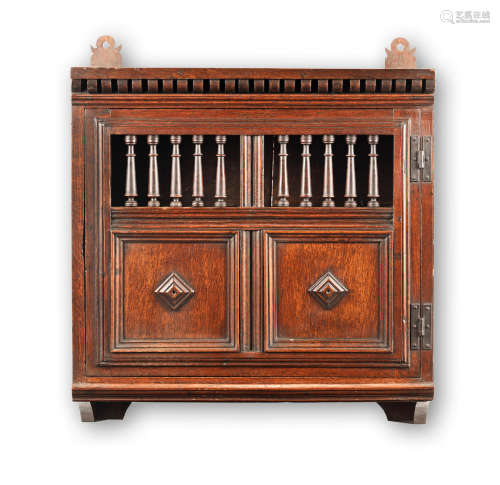 With period block printed lining paper A Charles II oak mural cupboard, circa 1670 and later