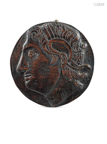 A 19th century carved oak roundel, depicting Alexander the Great