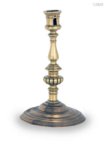 An unusual late 16th/early 17th century brass and bronze socket candlestick, French, circa 1600