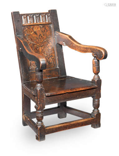 A Charles I joined oak, walnut and marquetry-inlaid adolescent's open armchair, circa 1640