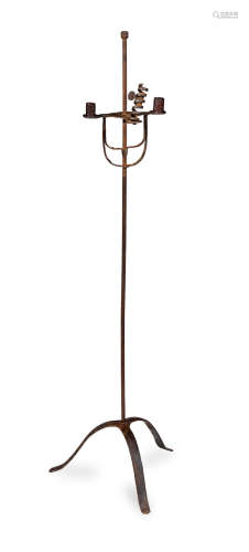 A wrought iron standing triple candleholder
