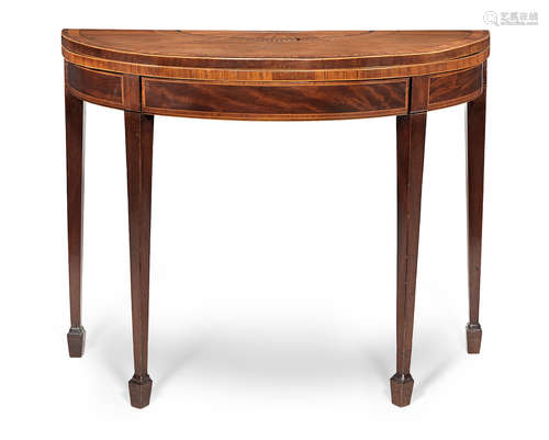 in the manner of Mayhew and Ince A George III mahogany, satinwood, tulipwood, ebony and marquetry demi-lune card table