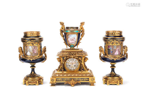 A late 19th century French gilt bronze mounted Sèvres style 'bleu de roi' porcelain mantel clock together with a pair of similar later garniture vases en-suite