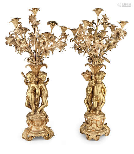 A pair of late 19th/early 20th century French gilt bronze seven light figural garniture candelabra