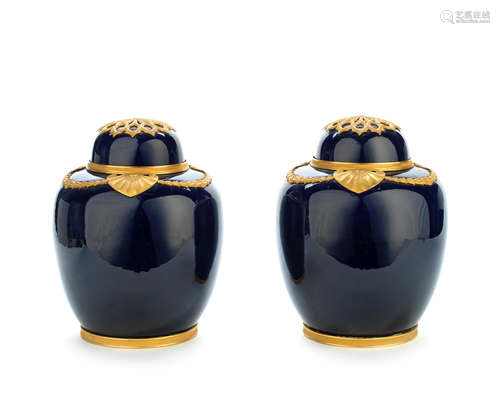 in the Sèvres style  A pair of gilt bronze mounted 'bleu de roi' porcelain garniture vases and covers