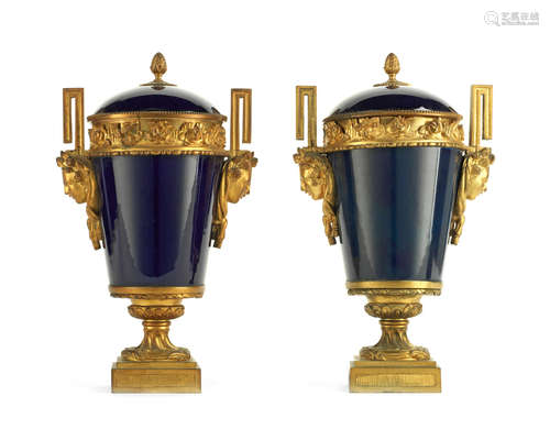 in the Louis XVI style A pair of late 19th century French gilt bronze mounted 'bleu de roi' porcelain garniture urns