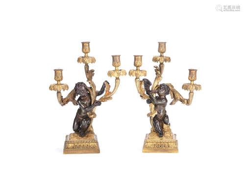 in the Louis XV style A pair of late 19th century French gilt and patinated bronze figural three light candelabra