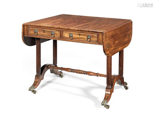 A Regency mahogany and brass inlaid double-sided sofa table of unusual proportions