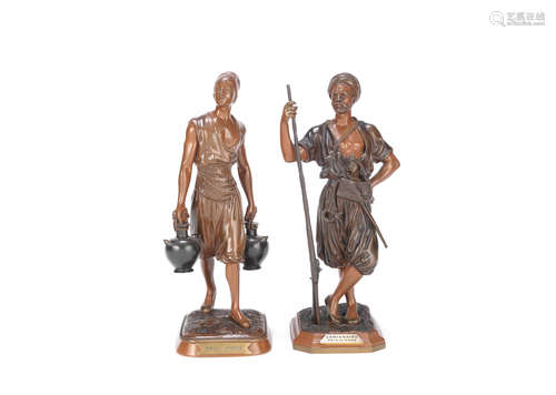 Marcel Debut (French, 1865-1933): A near pair of patinated bronze figures of an Arab warrior and a young Arab water carrier