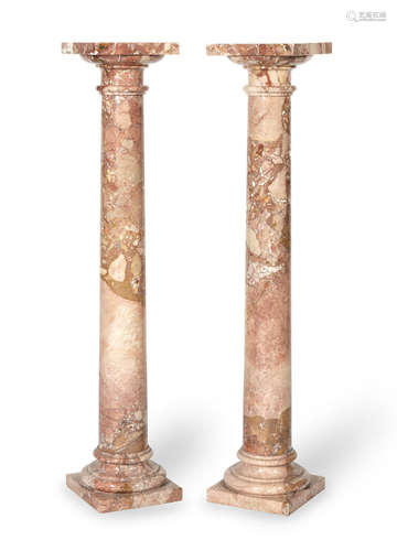 A pair of variegated pink marble column pedestals