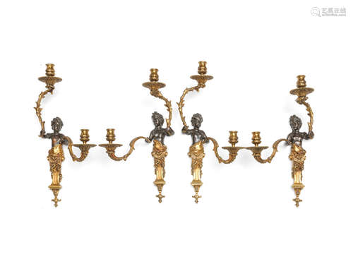 A set of four early 20th century French gilt and patinated bronze figural twin light wall appliques