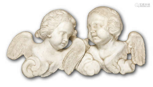 A pair of early 18th century carved white marble reliefs of winged puttos heads<br>				<br>				<br>					probably Frenchboth with scrolling hair, one looking to dexter, the other to sinister, the rear of each with iron suspension loops,  each 48cm high approximately  (2)<br>|Provenance: Purchased Harrods antique department.