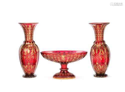 all in the Clichy style A pair of large and decorative Continental ruby cut and gilded glass vases together with a similar oval pedestal bowl en-suite