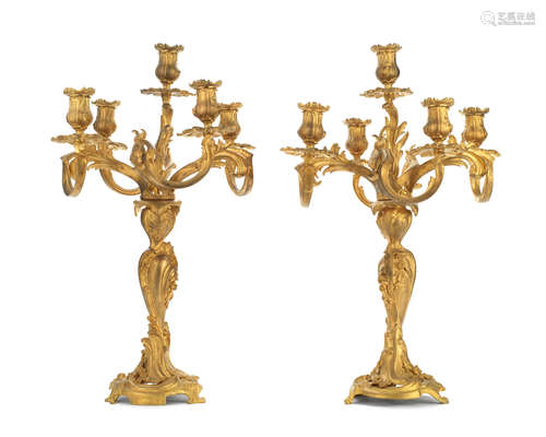 in the Louis XV style and in the manner of Henri Dasson  A pair of late 19th century gilt bronze five light candelabra