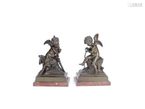 A pair of patinated bronze figures of winged putti